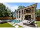 A spacious backyard features a modern pool, spa, lounge chairs, and well-manicured lawn, ideal for outdoor living at 2121 Laburnum Ave, Charlotte, NC 28205