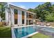 Beautiful backyard showcases a modern pool, spa, outdoor lounge, and lush lawn, perfect for relaxation at 2121 Laburnum Ave, Charlotte, NC 28205