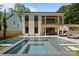 Modern backyard features a refreshing pool with spa, lounge area, and well-maintained landscaping at 2121 Laburnum Ave, Charlotte, NC 28205