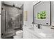 Modern bathroom featuring a glass enclosed shower with gray tile and a sleek white vanity at 2121 Laburnum Ave, Charlotte, NC 28205