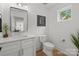 Bright bathroom featuring a modern vanity, hardwood floors, and a sunny window at 2121 Laburnum Ave, Charlotte, NC 28205