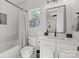 Stylish bathroom with a tub-shower combo, modern vanity, and elegant fixtures at 2121 Laburnum Ave, Charlotte, NC 28205
