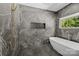 Spa-like bathroom featuring a soaking tub, sleek tile work, and a modern shower system at 2121 Laburnum Ave, Charlotte, NC 28205