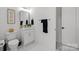 Well-lit modern bathroom with a vessel sink, white cabinets and a decorative mirror at 2121 Laburnum Ave, Charlotte, NC 28205