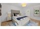 Bright bedroom showcasing a plush headboard, soft rug, and stylish accent lighting at 2121 Laburnum Ave, Charlotte, NC 28205