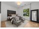 Cozy bedroom featuring a plush headboard, hardwood floors, and a window with natural light at 2121 Laburnum Ave, Charlotte, NC 28205