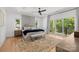 Spacious main bedroom with hardwood floors, a plush rug, and balcony access overlooking the greenery at 2121 Laburnum Ave, Charlotte, NC 28205