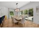 Elegant dining area with hardwood floors, modern lighting, and sliding doors to an outdoor patio at 2121 Laburnum Ave, Charlotte, NC 28205