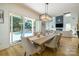 Elegant dining room with a modern chandelier, hardwood floors, and access to the pool area at 2121 Laburnum Ave, Charlotte, NC 28205