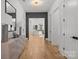Bright entryway features hardwood floors, a modern light fixture, and a glimpse into the living room at 2121 Laburnum Ave, Charlotte, NC 28205