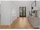 Bright entryway features hardwood floors and views of the front yard through glass paned double doors at 2121 Laburnum Ave, Charlotte, NC 28205