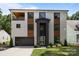 Modern two-story home featuring a stylish facade, balcony, and well-manicured landscaping at 2121 Laburnum Ave, Charlotte, NC 28205