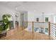 Bright hallway with hardwood floors, modern railing, and views of the pool at 2121 Laburnum Ave, Charlotte, NC 28205