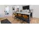 Open kitchen boasts a large island with bar seating, stainless steel appliances, and hardwood floors at 2121 Laburnum Ave, Charlotte, NC 28205