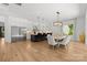 Open-concept kitchen and dining area with large island and modern light fixtures at 2121 Laburnum Ave, Charlotte, NC 28205
