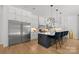 Bright, open kitchen with island seating, stainless steel appliances, and custom white cabinetry at 2121 Laburnum Ave, Charlotte, NC 28205