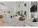 Spacious living room with a modern fireplace, large windows, and hardwood floors at 2121 Laburnum Ave, Charlotte, NC 28205
