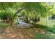 Scenic backyard view of wood deck with an adjacent sunroom and a lush, private setting at 220 Blackberry Trl, Concord, NC 28027
