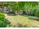 Lush, expansive backyard featuring mature trees and ample space for recreation and gardening at 220 Blackberry Trl, Concord, NC 28027