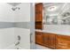 Bathroom features tiled tub and shower combo with built-in storage and vanity with cabinets at 220 Blackberry Trl, Concord, NC 28027