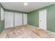 Bedroom with green walls, carpeted floors, closet and windows with shutters at 220 Blackberry Trl, Concord, NC 28027