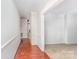 Hallway with hardwood floors leading into a carpeted room at 220 Blackberry Trl, Concord, NC 28027