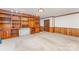 Large living room with wood paneled walls and built in shelving at 220 Blackberry Trl, Concord, NC 28027