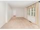 Spacious living room with neutral carpet, large window, and a doorway to another room at 220 Blackberry Trl, Concord, NC 28027