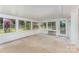 Bright sunroom surrounded by windows with white trim and an exterior door leading outside at 220 Blackberry Trl, Concord, NC 28027