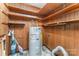 Utility room features shelving, wood paneled walls, and an electric hot water heater at 220 Blackberry Trl, Concord, NC 28027