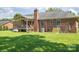 Expansive backyard featuring a well-maintained lawn, a back porch, and mature trees, offering ample space for recreation at 233 Reliance Rd, Kings Mountain, NC 28086