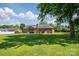 Expansive backyard featuring a well-maintained lawn, a back porch, and mature trees, offering ample space for recreation at 233 Reliance Rd, Kings Mountain, NC 28086