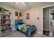 Bright, fun bedroom with a twin bed, vibrant artwork, and a full bookshelf, ideal for a personal space at 233 Reliance Rd, Kings Mountain, NC 28086