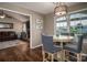 Inviting dining area featuring wood floors, a round table with chairs, and views of the living room with a fireplace at 233 Reliance Rd, Kings Mountain, NC 28086