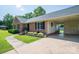 Charming brick home with a covered carport, manicured lawn, and lush landscaping at 233 Reliance Rd, Kings Mountain, NC 28086