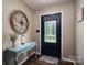 Inviting foyer features a stylish front door with decorative glass, a blue console table, and wood flooring at 233 Reliance Rd, Kings Mountain, NC 28086