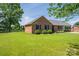 Expansive lawn and brick home with manicured shrubbery and complementary window shutters at 233 Reliance Rd, Kings Mountain, NC 28086