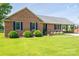 Inviting single-story brick home with lush front lawn, tasteful landscaping, and a convenient covered carport at 233 Reliance Rd, Kings Mountain, NC 28086