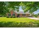 Lovely single-story brick home with a covered carport and a well-manicured lawn, shaded by mature trees at 233 Reliance Rd, Kings Mountain, NC 28086