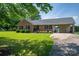 Beautiful brick home featuring blue shutters, manicured landscaping, and an attached carport on a spacious lot at 233 Reliance Rd, Kings Mountain, NC 28086