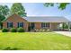 Single-story brick home with well-kept lawn, classic shutters, and a convenient covered carport at 233 Reliance Rd, Kings Mountain, NC 28086