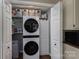 Convenient laundry area with a stacked washer/dryer, shelving, and ample storage, tucked neatly behind closet doors at 233 Reliance Rd, Kings Mountain, NC 28086