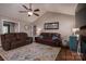 Bright living room featuring vaulted ceilings, a brick fireplace, and comfortable leather sofas, perfect for relaxing at 233 Reliance Rd, Kings Mountain, NC 28086