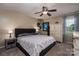 Comfortable main bedroom with ceiling fan, a cozy gray bed, and a decorative cabinet, offering a relaxing retreat at 233 Reliance Rd, Kings Mountain, NC 28086