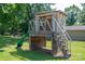 Wooden playset with a green slide and stairs offers a fun backyard feature for entertainment at 233 Reliance Rd, Kings Mountain, NC 28086