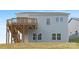 Backyard featuring a wooden deck with stairs, light blue siding, green grass, and several windows at 24578 Blue Heron Cir # 407, Lancaster, SC 29720
