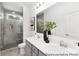 Bathroom featuring double sinks, a large mirror, and a glass shower at 24578 Blue Heron Cir # 407, Lancaster, SC 29720