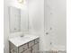 Bathroom featuring a large mirror, gray vanity, and modern sink at 24578 Blue Heron Cir # 407, Lancaster, SC 29720