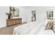 Comfortable bedroom with neutral colors, wood dresser, and a glimpse into the living area at 24578 Blue Heron Cir # 407, Lancaster, SC 29720