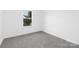 Neat, minimalist bedroom with gray carpet and a window view of greenery at 24578 Blue Heron Cir # 407, Lancaster, SC 29720